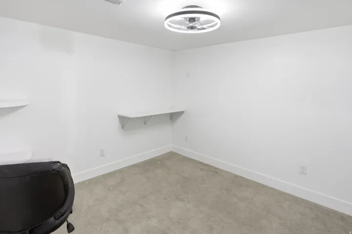 Neutral color palette with white walls, baseboards, and built-in shelving