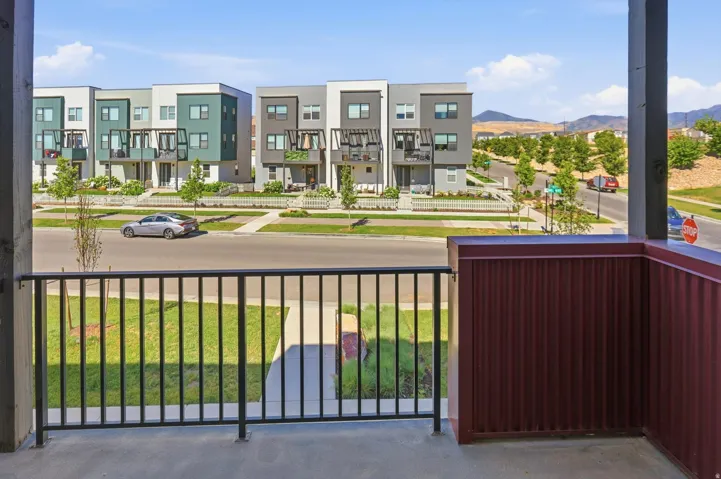 Balcony with black metal railings and a corrugated red metal wall