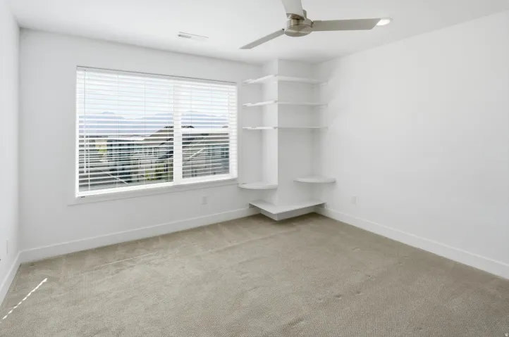 Bright interior with a large window featuring horizontal blinds