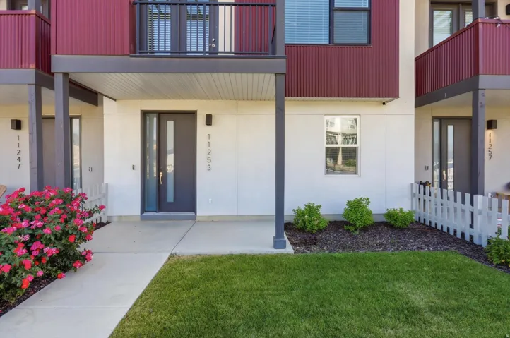 Modern facade featuring white stucco and corrugated metal siding