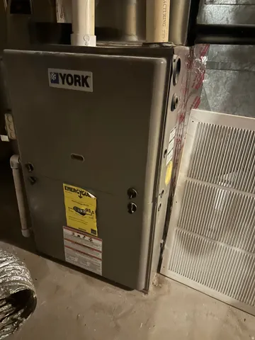York brand furnace unit with visible Energy Guide label indicating 95.5 AFUE