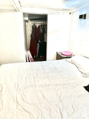 Built-in closet featuring wire shelving and a wall-mounted sconce