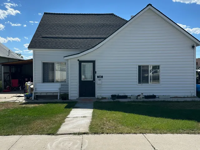 White siding exterior with a dark shingle roof