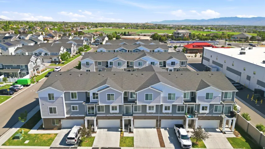 Modern townhomes featuring multi-tone siding and individual garages