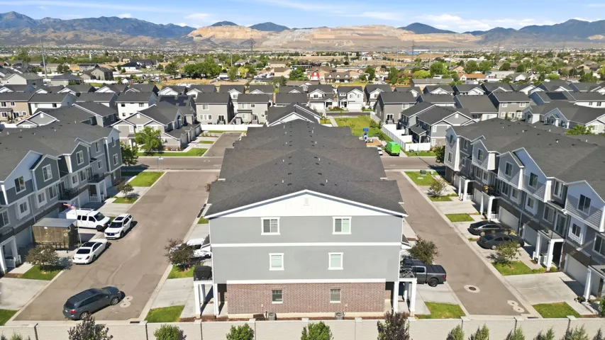 Townhome community featuring modern architectural styles, asphalt shingle roofs, and light-colored siding facades