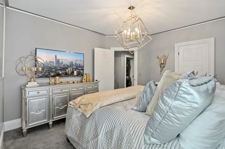 Recessed lighting accents the ceiling, complemented by a geometric gold-tone chandelier