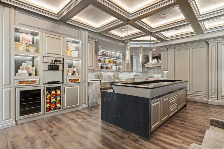 Custom built-in cabinetry with illuminated shelving, integrated soft-serve machine, and beverage cooler