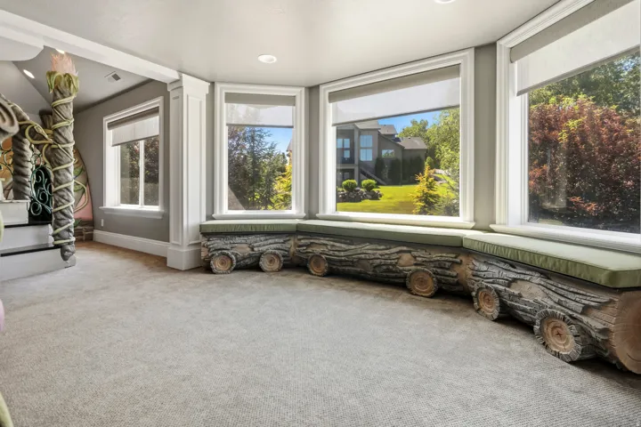 Bay window featuring a built-in bench with integrated log-style detailing and green cushions