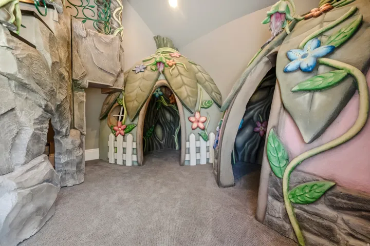 Custom-built interior play area featuring sculpted rock formations and whimsical, nature-themed structures