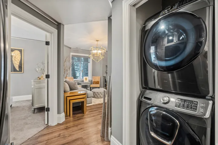 Integrated stacked washer and dryer in a dedicated utility alcove