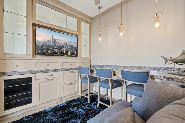 Built-in media center with integrated television and upper display cabinetry