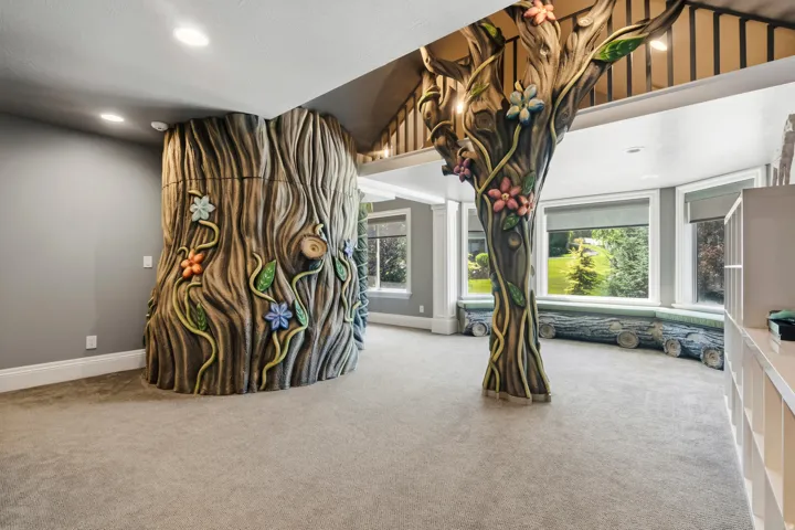 Themed interior featuring two tree-like architectural columns with intricate floral and vine detailing