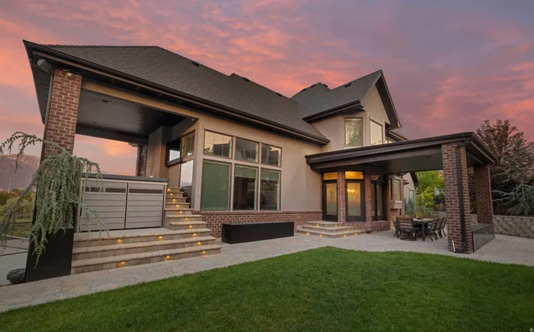 Contemporary stucco and brick exterior featuring multiple outdoor living spaces
