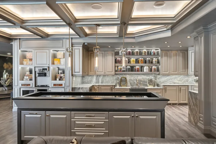Contemporary entertainment space featuring a coffered ceiling with integrated lighting