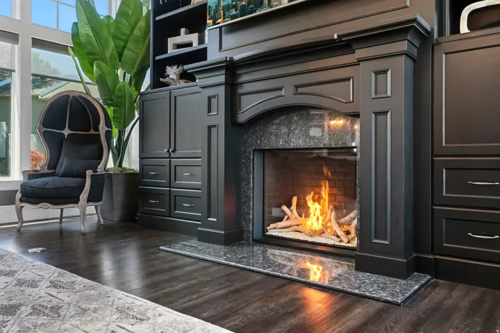 Built-in fireplace with a stone surround and hearth