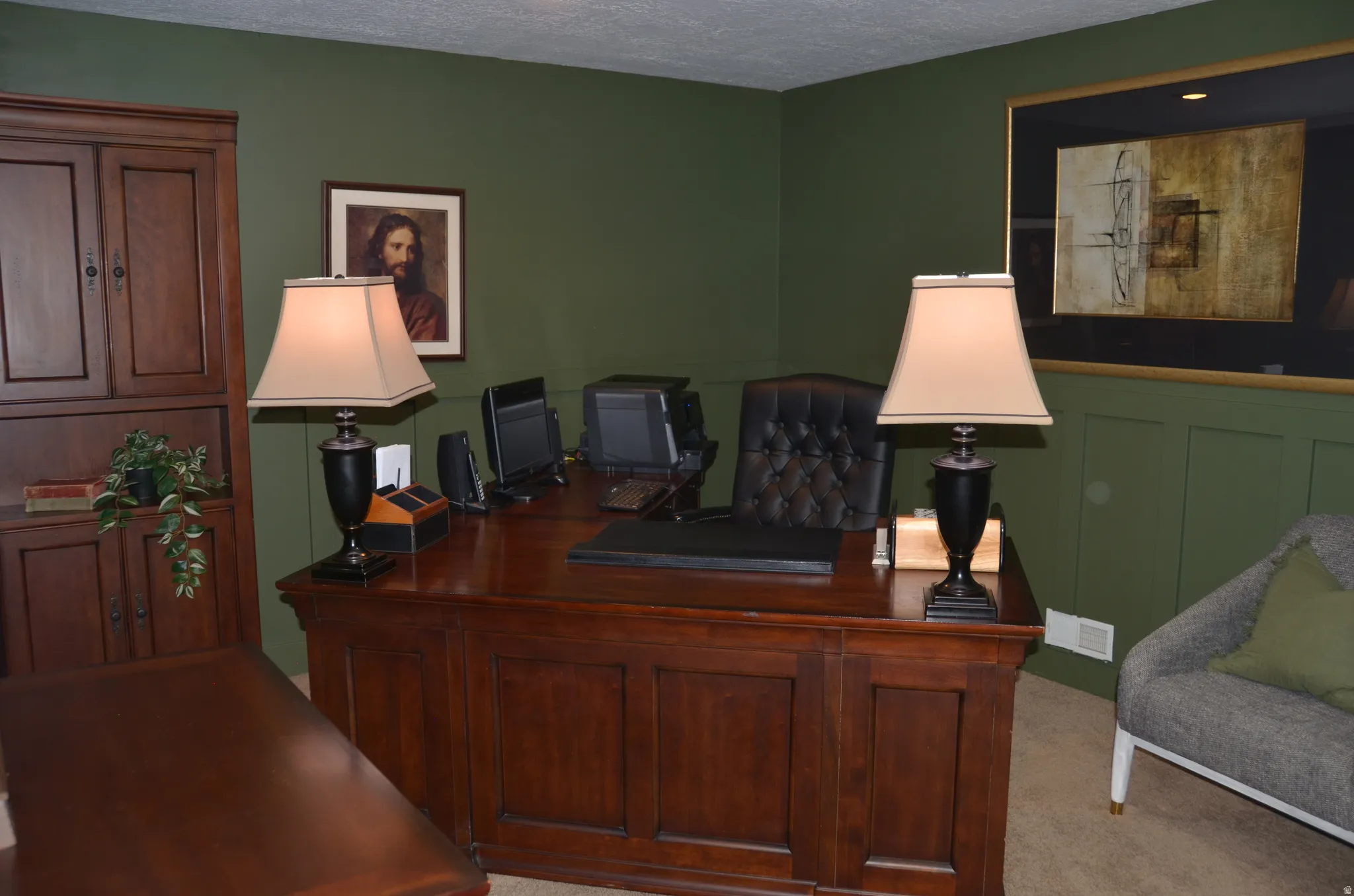 Office area featuring wood-finish built-in cabinetry, recessed lighting, and wall paneling