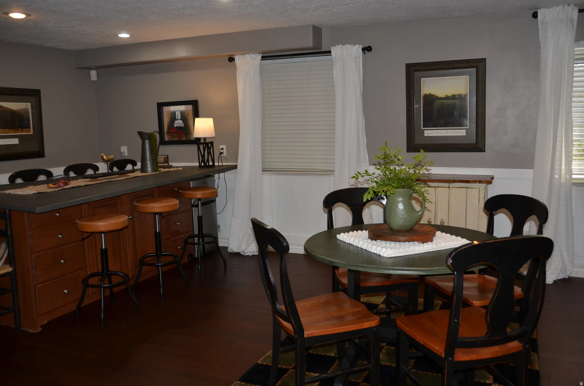 Spacious room featuring rich wood-finish flooring