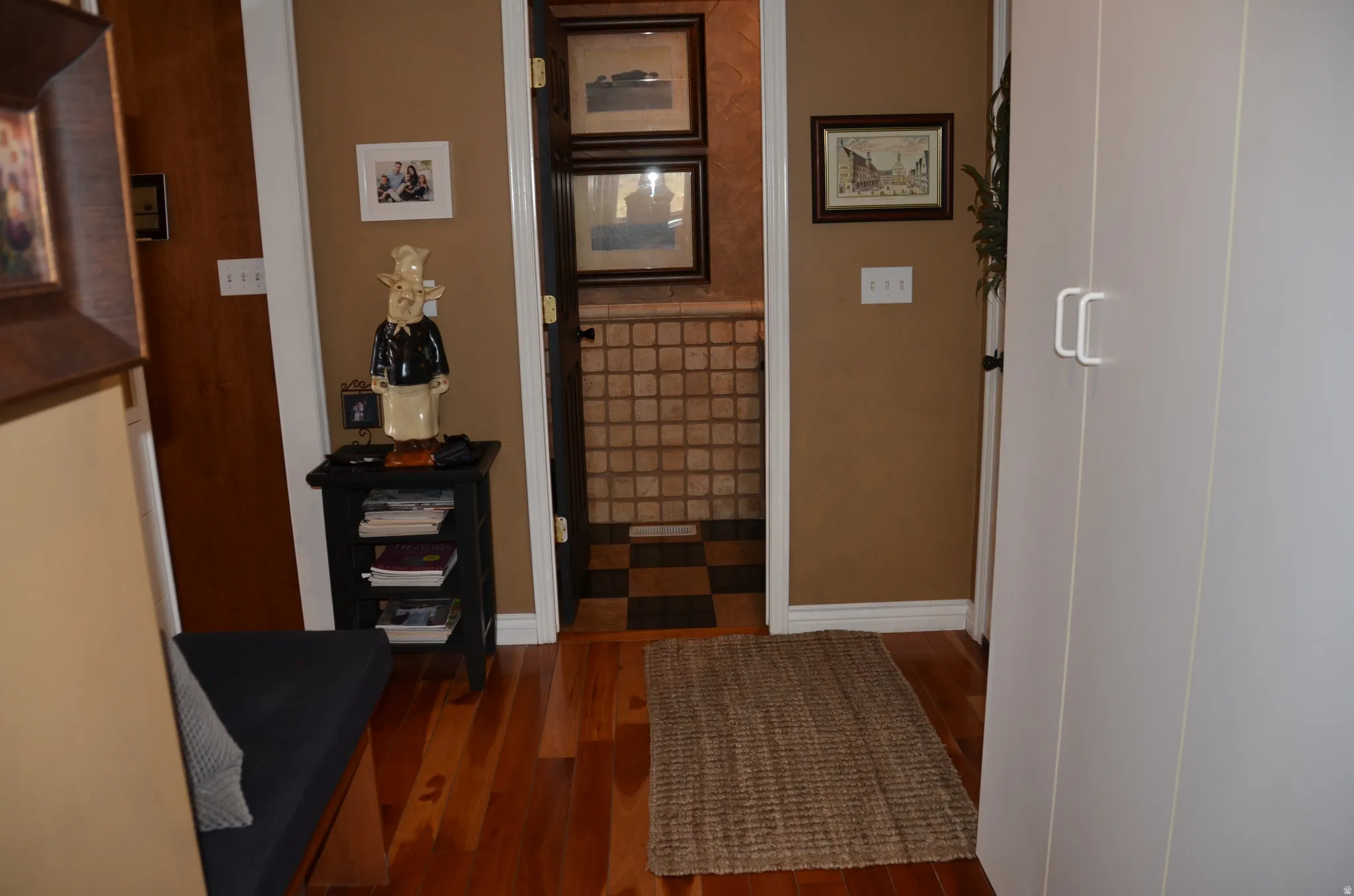 Hardwood flooring extends throughout this hallway with lockers