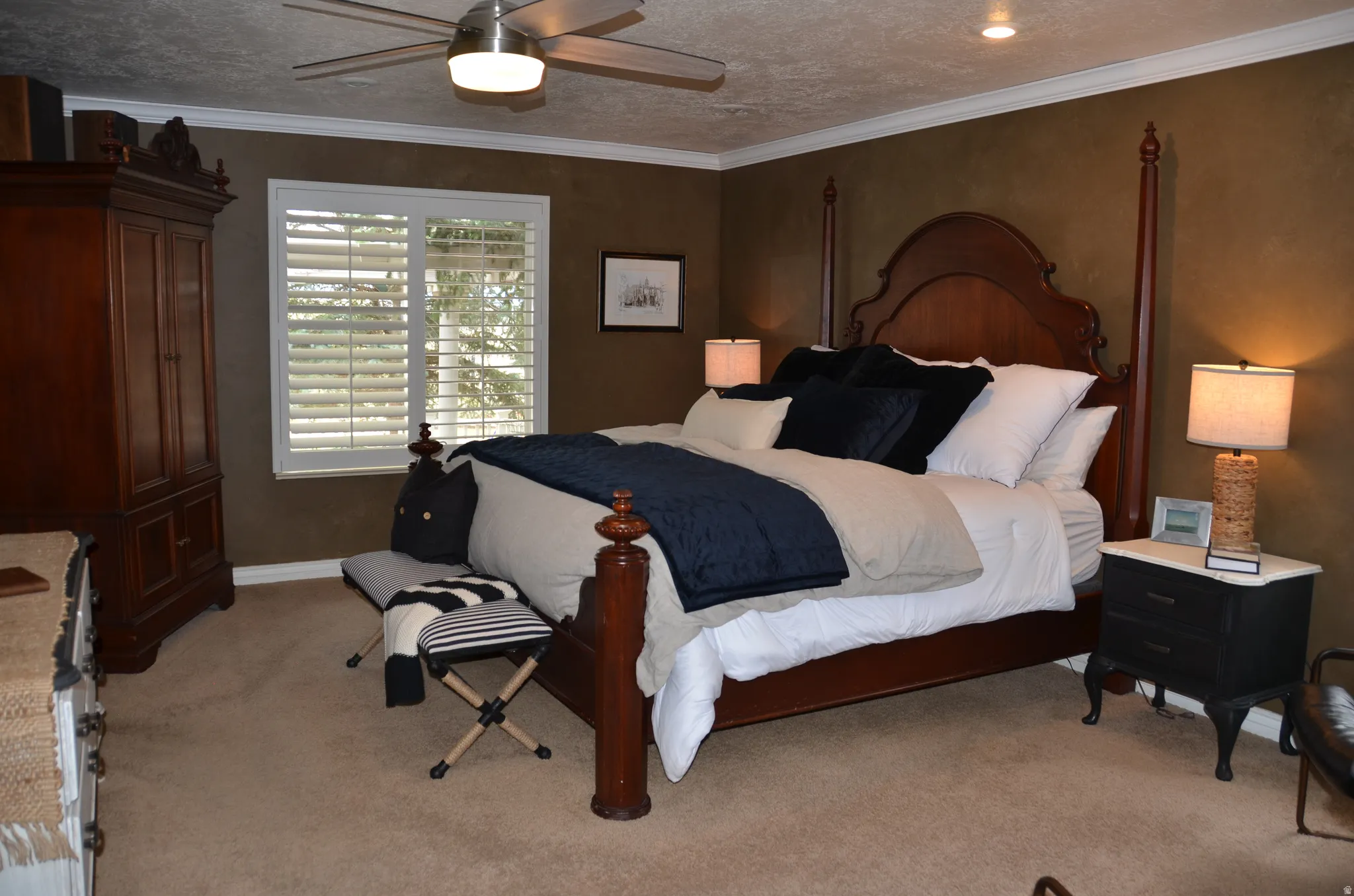Spacious master bedroom featuring a ceiling fan with integrated lighting, recessed lighting, crown molding, and a window with white plantation shutters