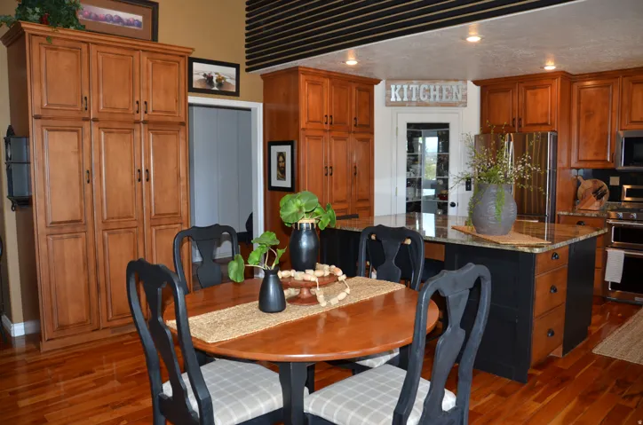 Kitchen area featuring wood flooring, recessed lighting, and rich wood cabinetry