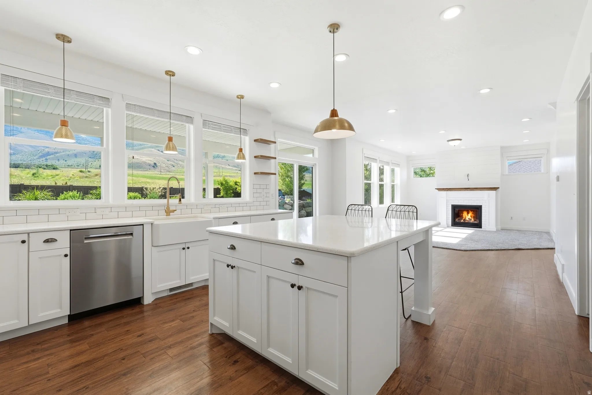 Kitchen and living area featuring wood-finish flooring
