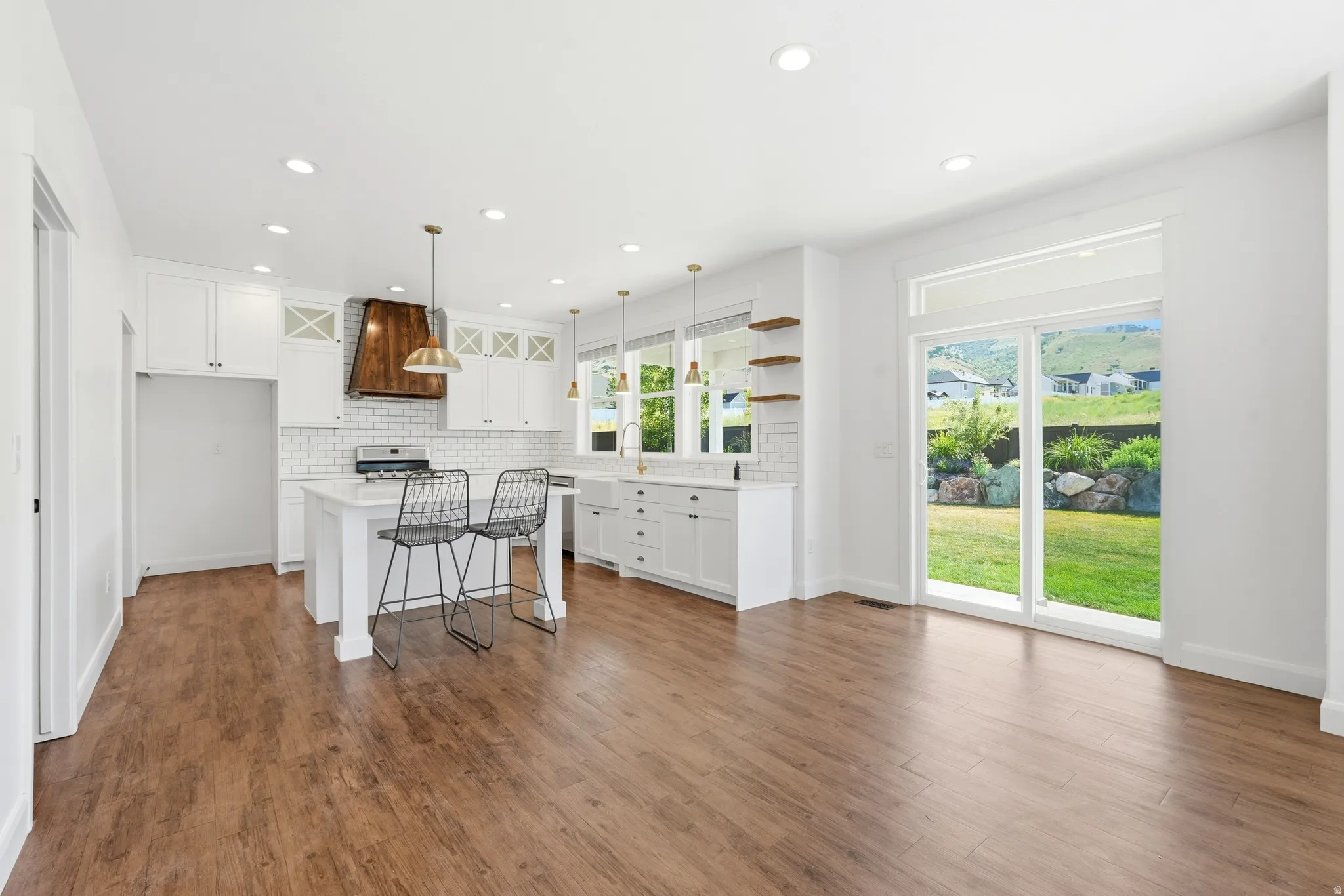Open-concept living space with wood-finish flooring