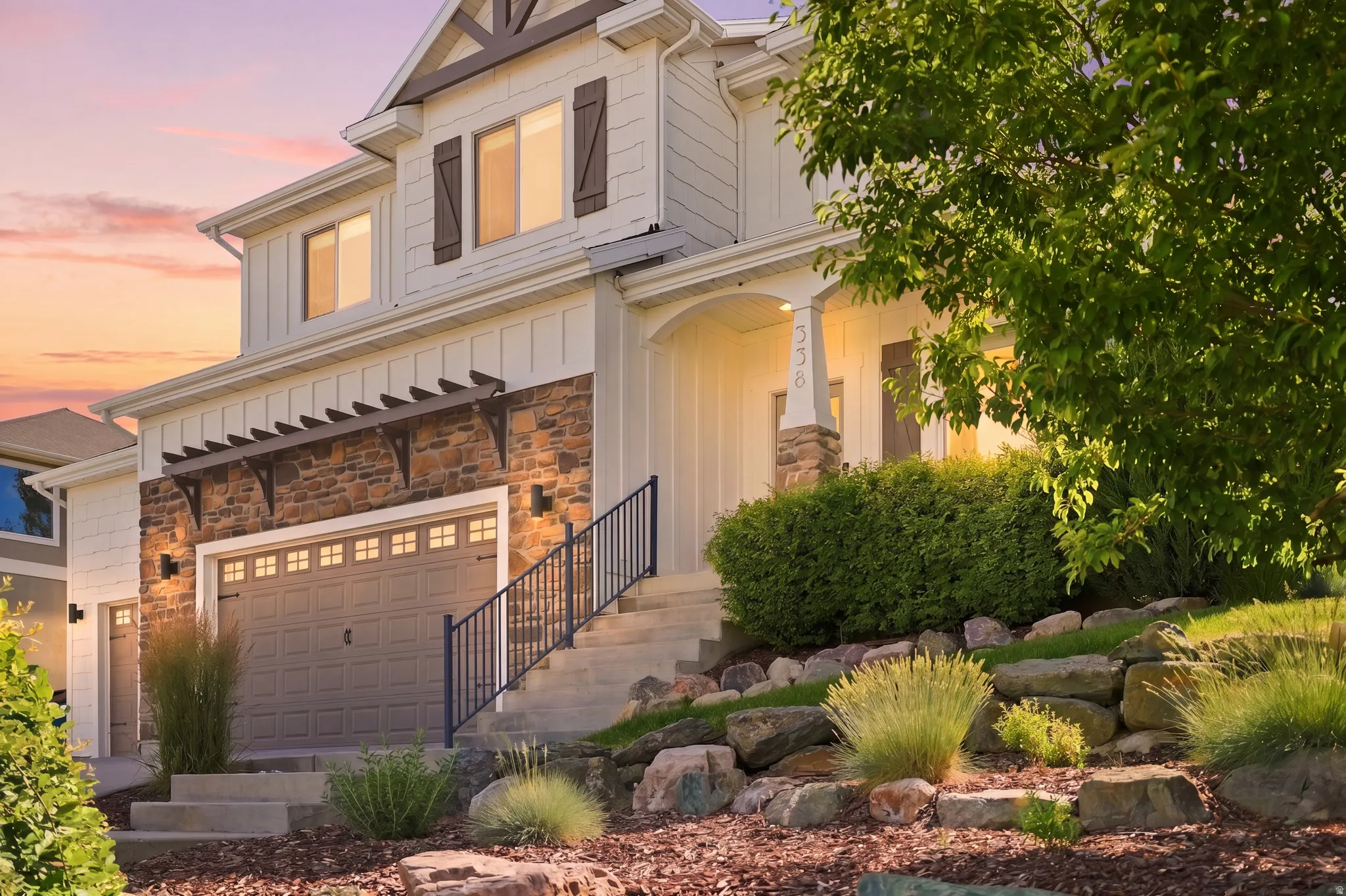 Multi-story exterior with stone veneer and horizontal siding