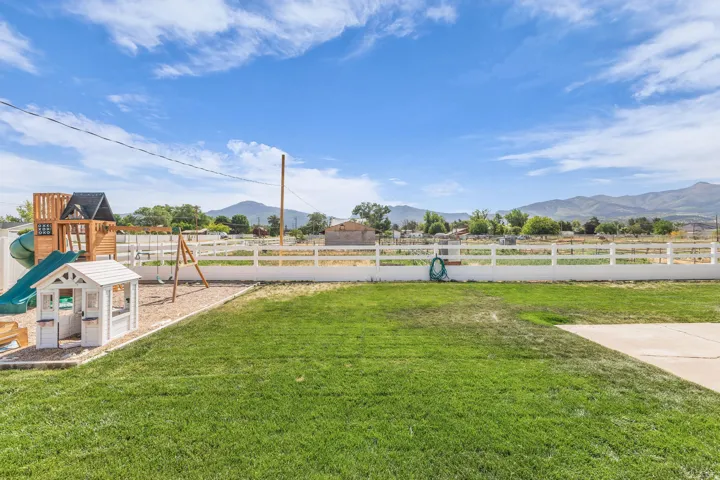 Spacious outdoor area with a green lawn and concrete patio