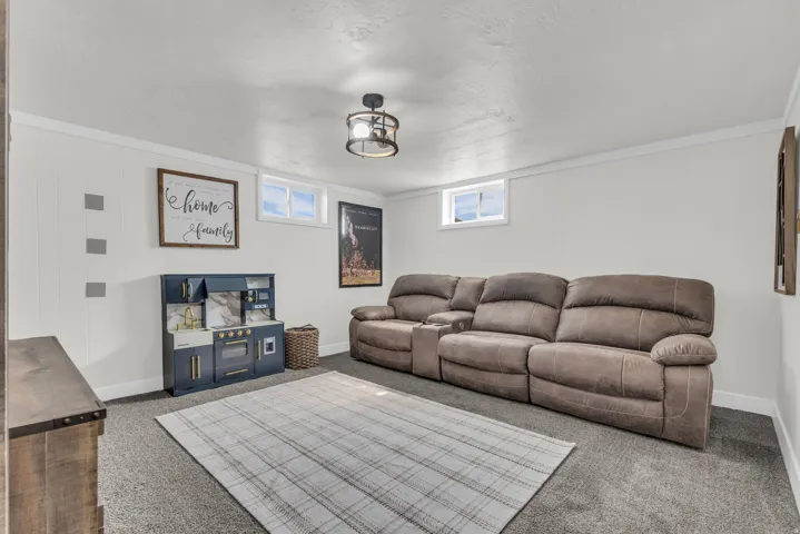 Carpeted room featuring white walls, white trim, and two egress windows