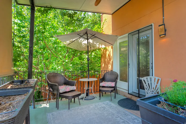 Covered outdoor patio/deck featuring an orange stucco exterior