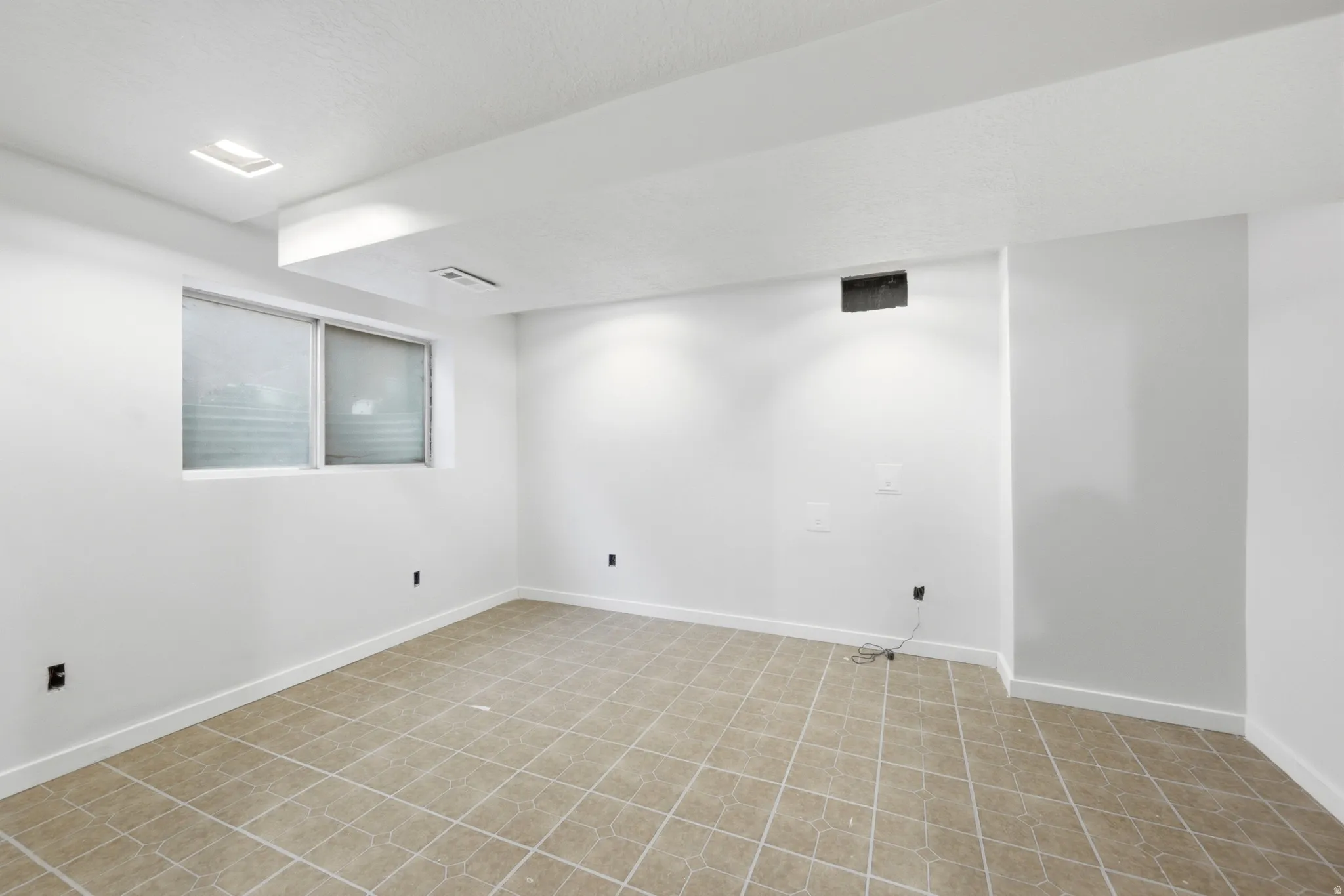 Recessed lighting and ceiling-mounted light fixtures illuminate the space