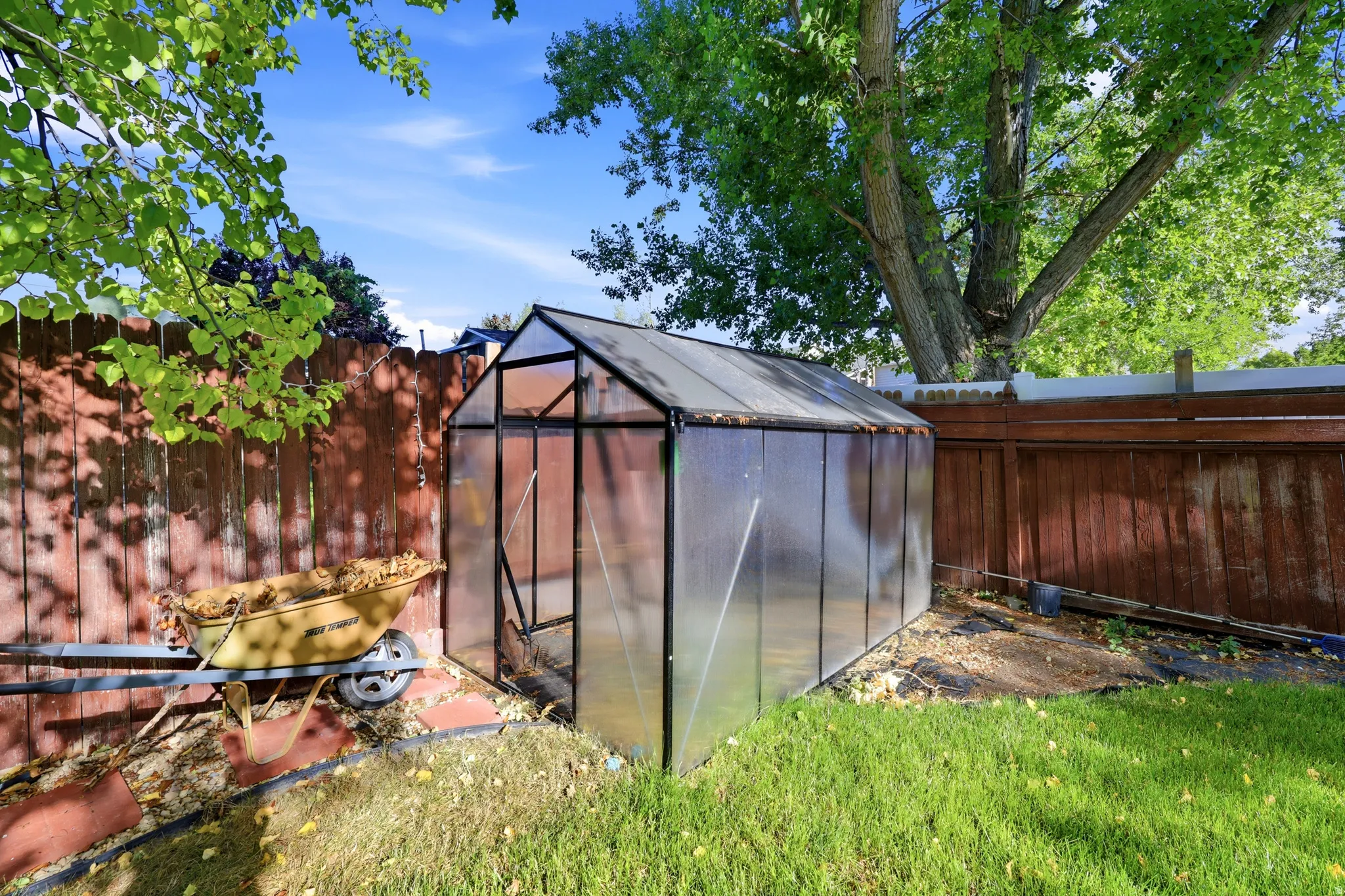 Freestanding greenhouse with a metal frame and translucent panels
