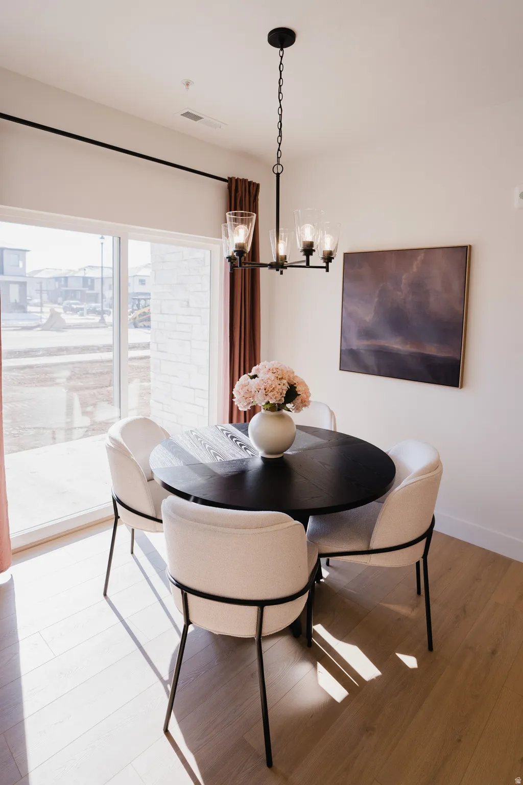 Recessed lighting and a multi-light chandelier illuminate this space