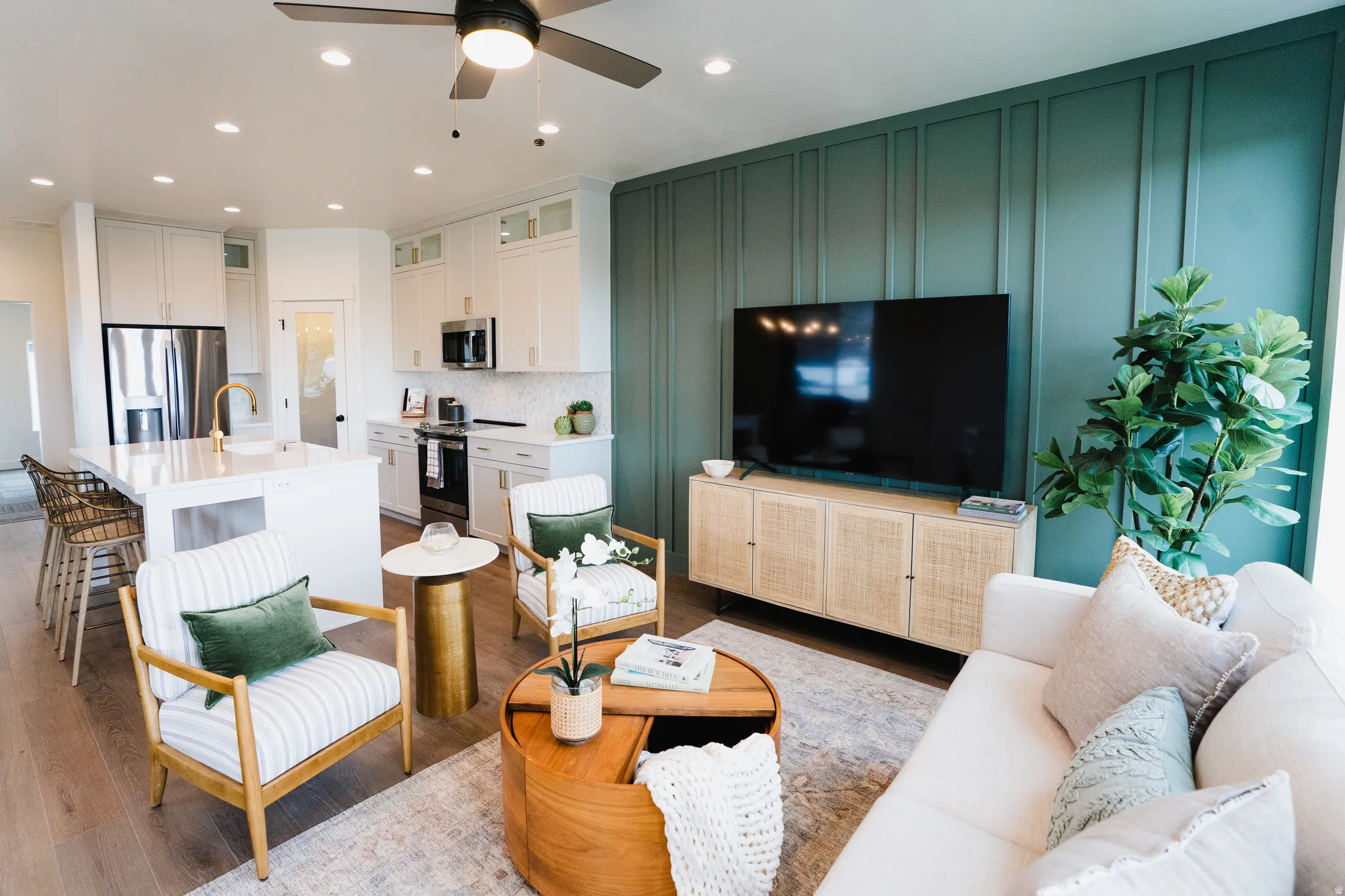 Open-concept living area featuring wood-finish flooring, recessed lighting, and a ceiling fan