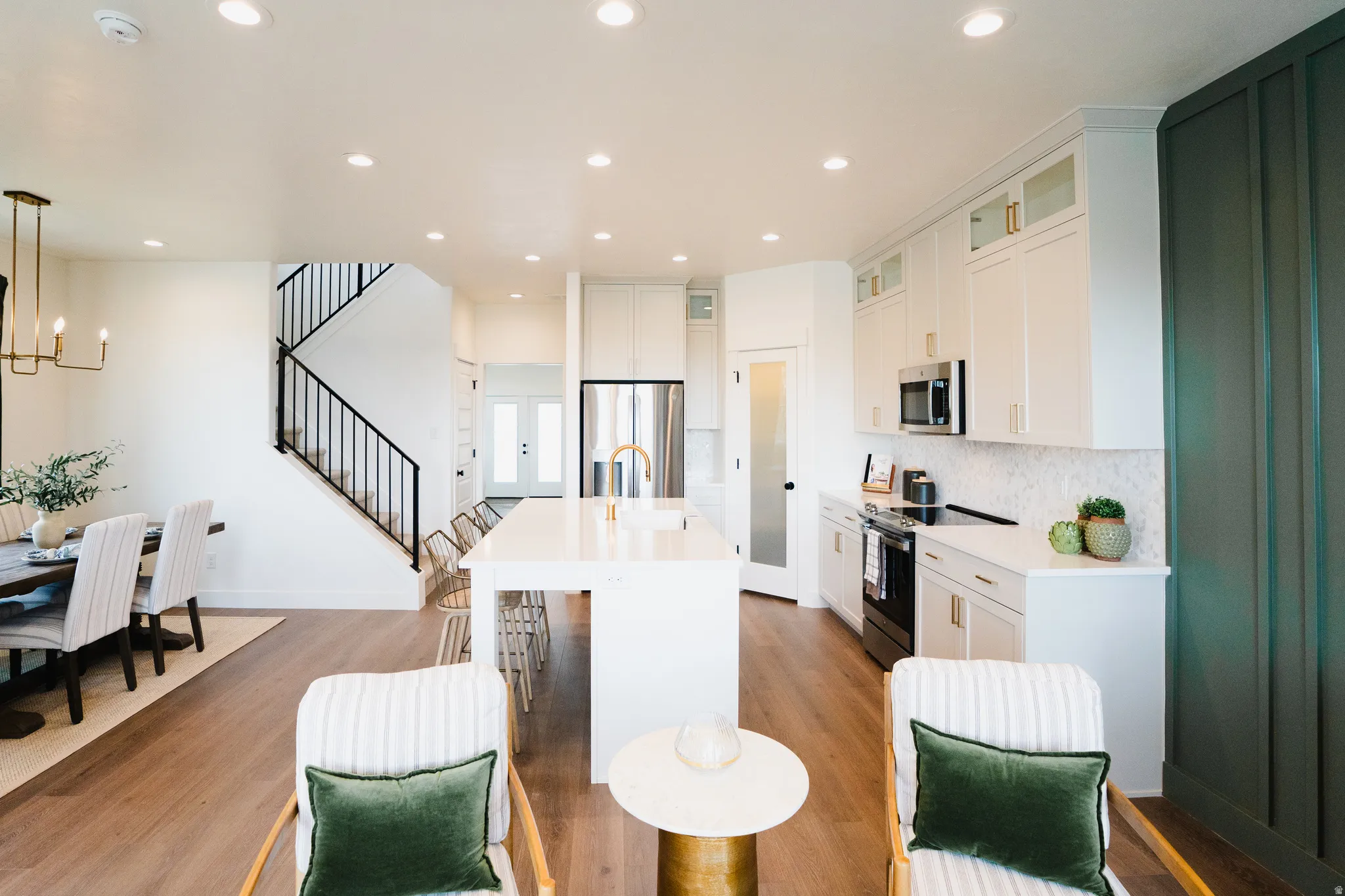 Open-concept living space featuring wood-finish flooring and recessed lighting