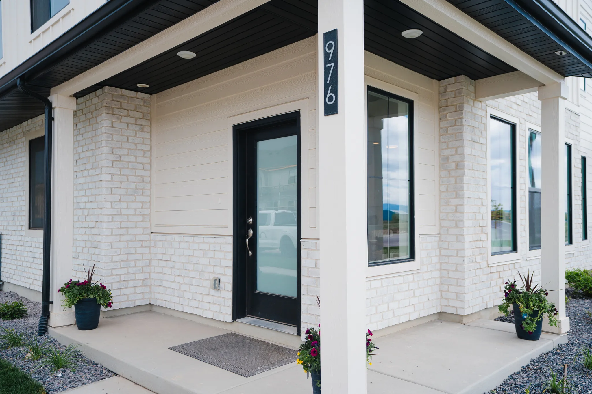 Modern exterior featuring white brick and siding accents