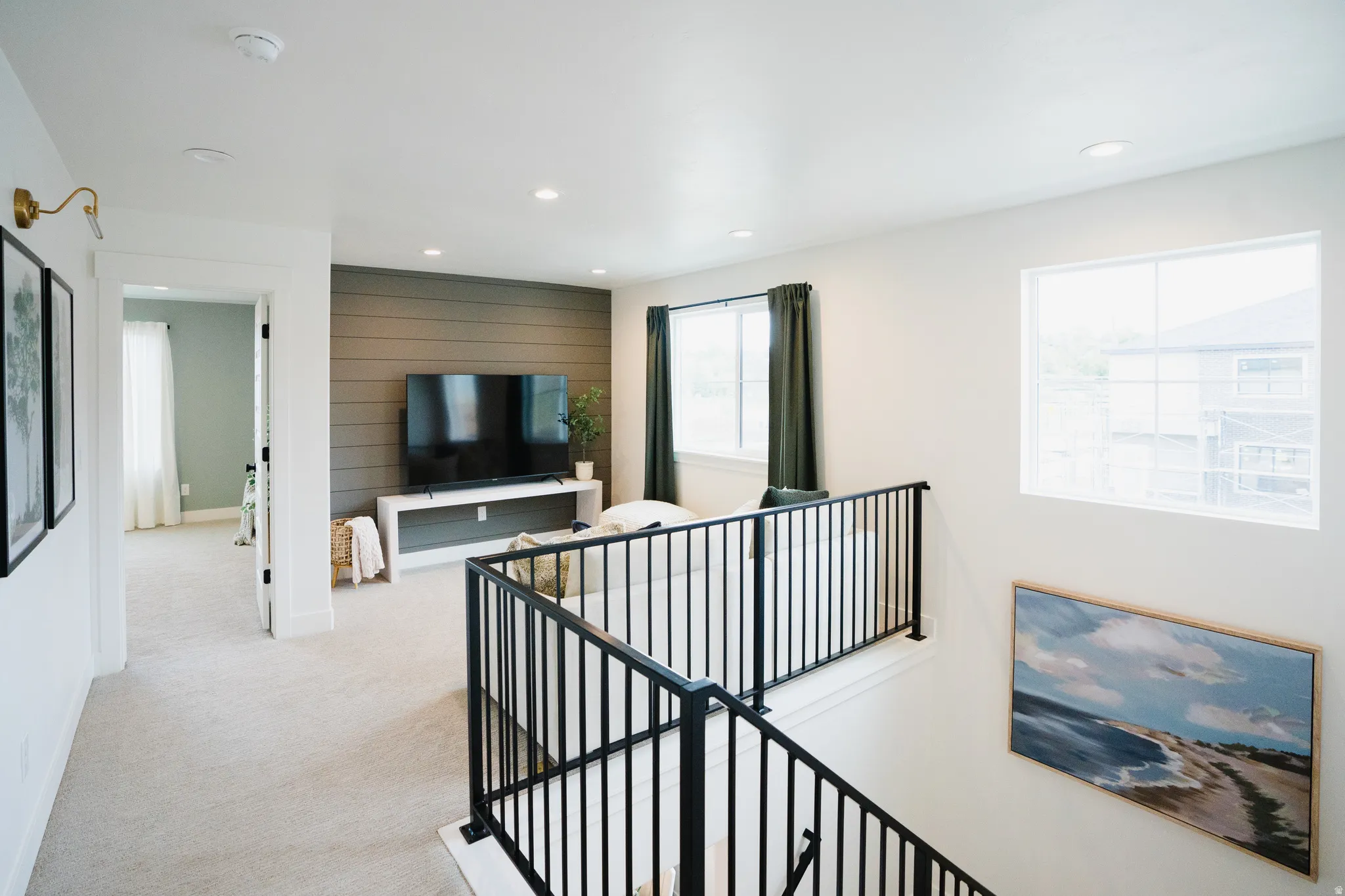 Loft area featuring a distinctive shiplap accent wall, recessed lighting, and carpeted flooring