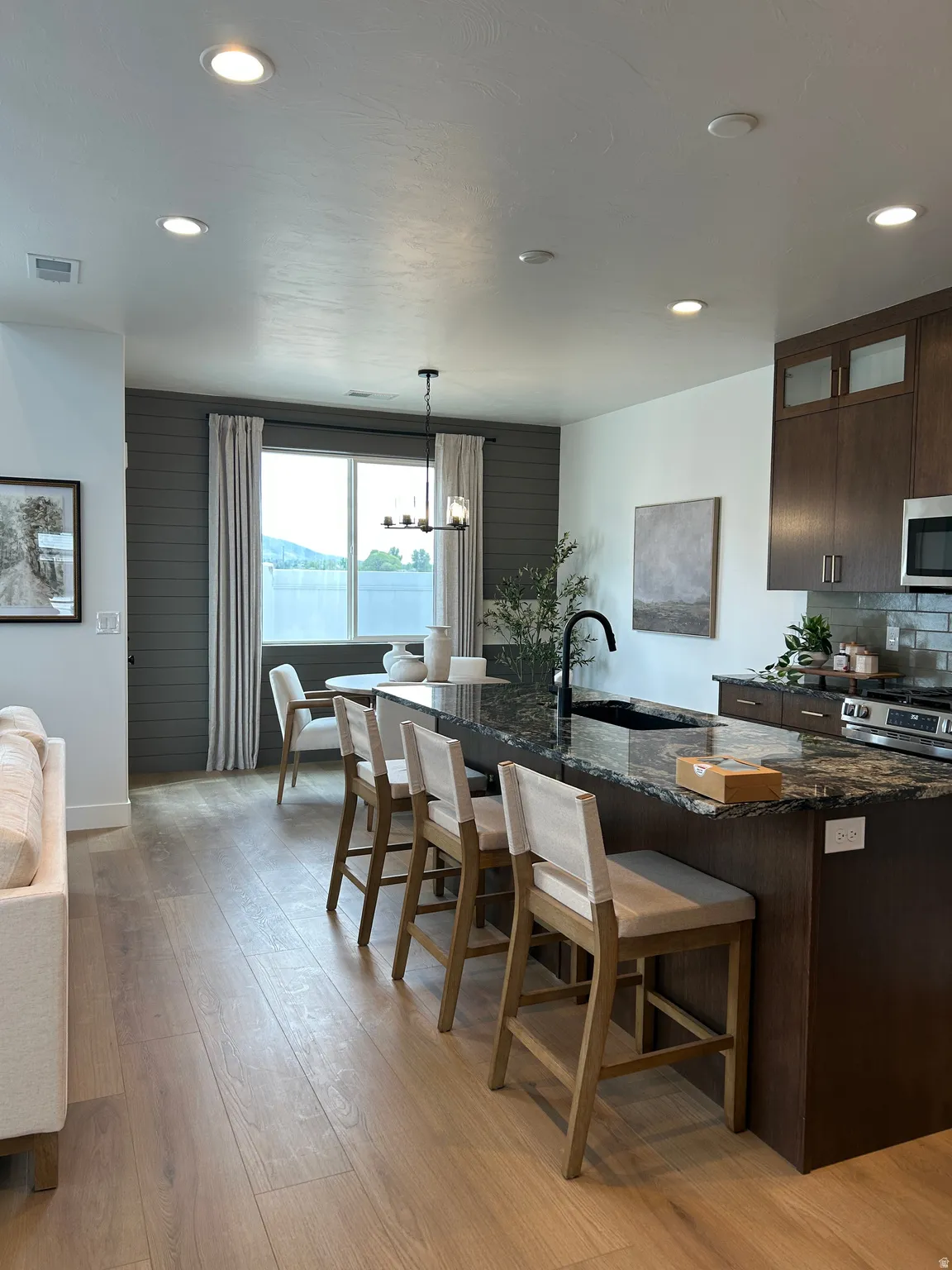 Modern kitchen island with a dark granite countertop and integrated sink