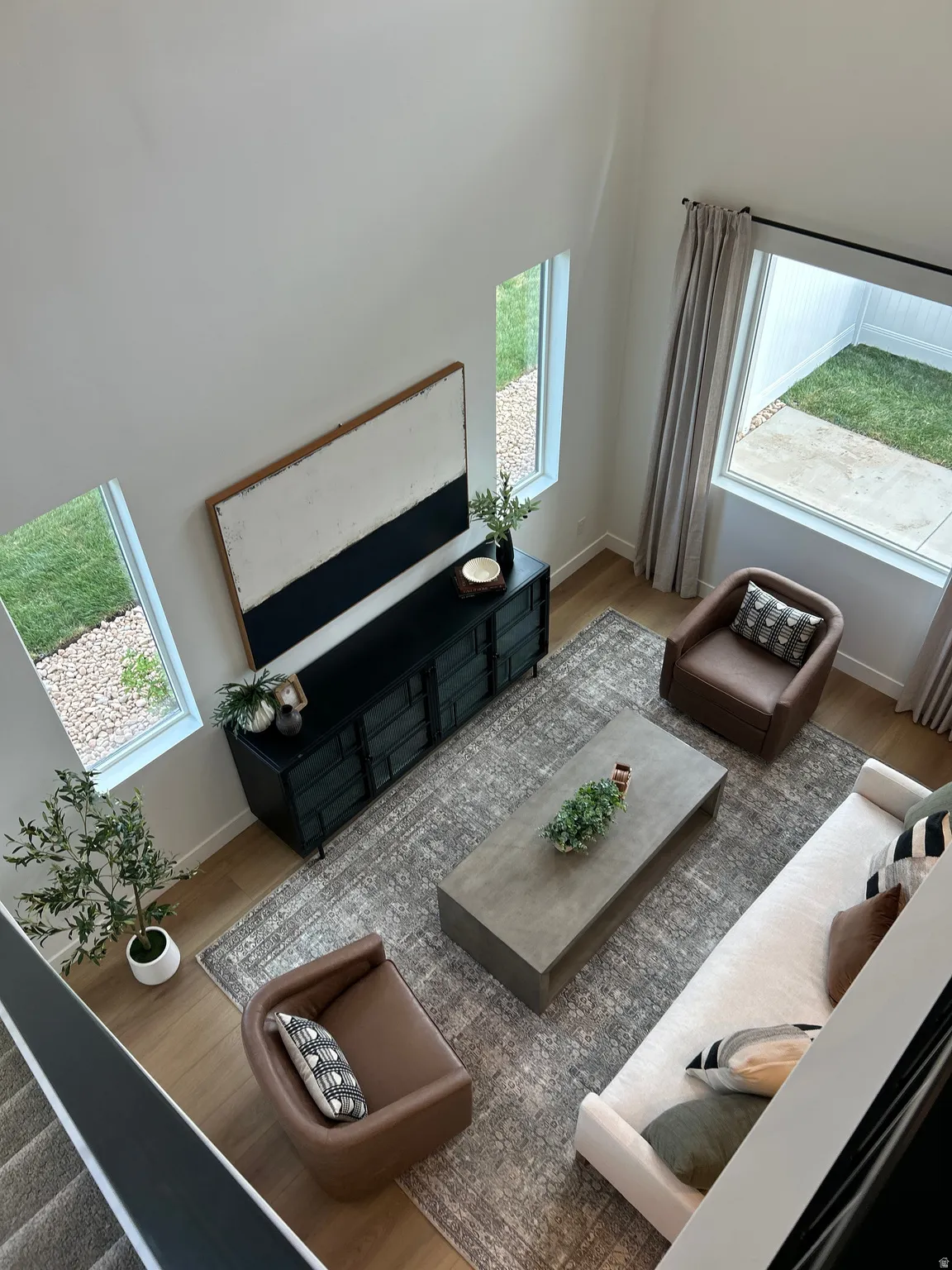 Two-story living area featuring high ceilings and wood-finish flooring