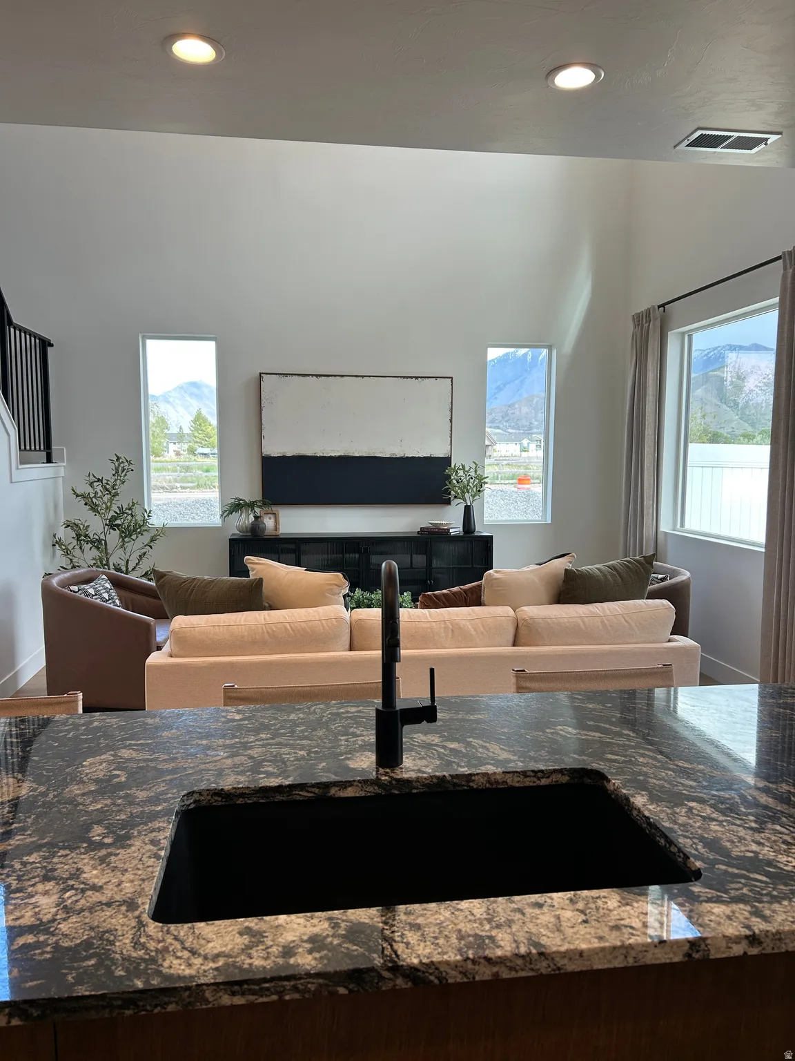 Granite-look countertop with an undermount sink and matte black faucet