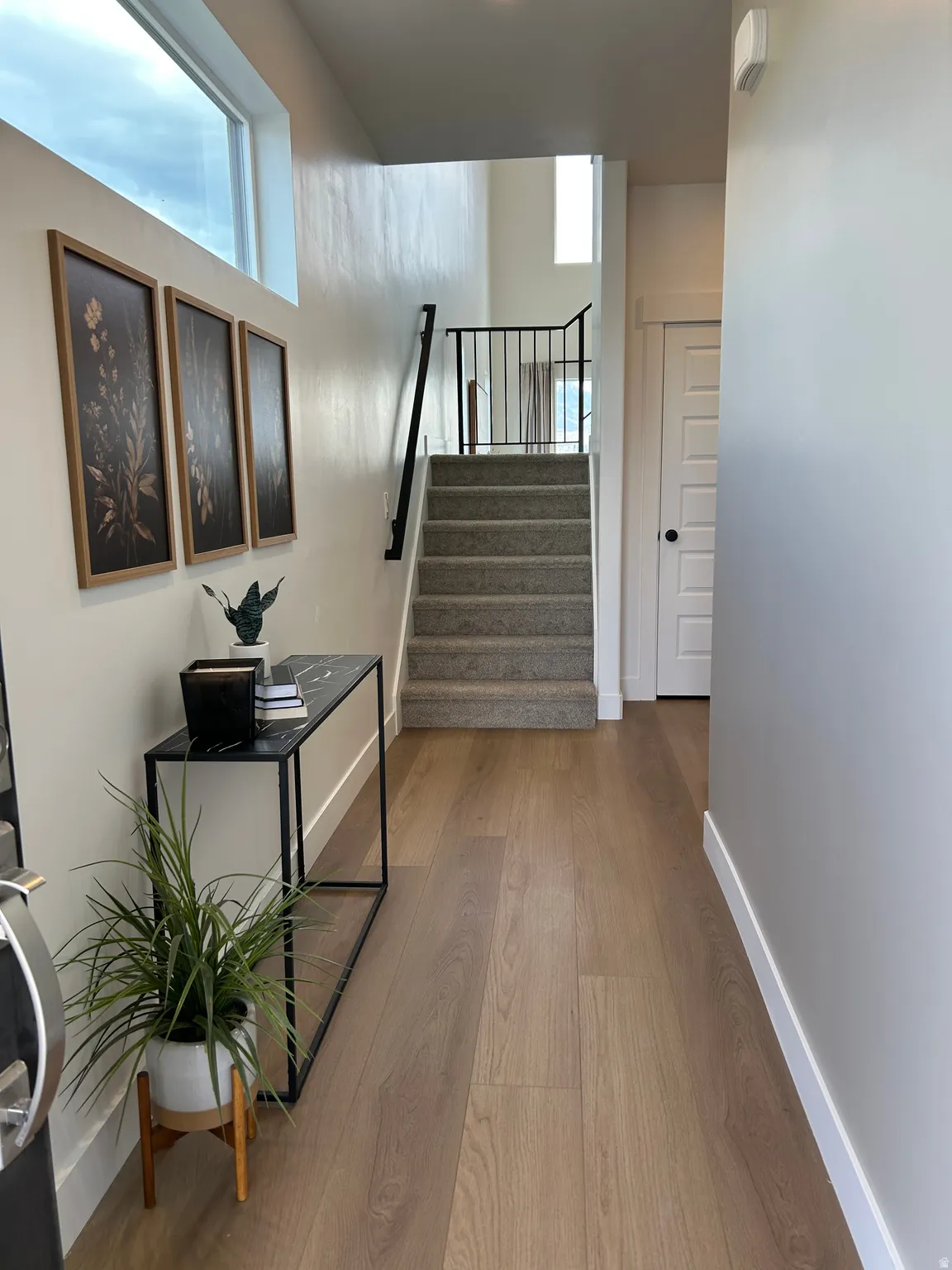 Entryway featuring light wood-finish flooring, white baseboards, and a neutral wall palette