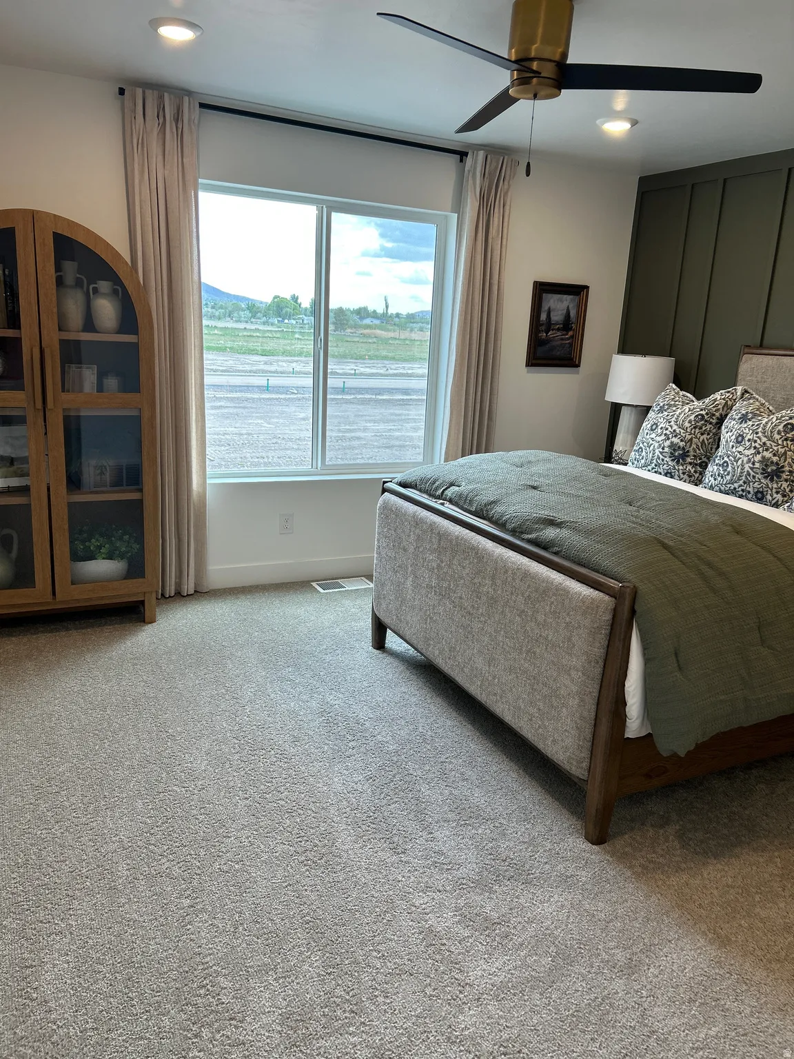 Bedroom featuring a large window, recessed lighting, and a ceiling fan with gold-tone hardware
