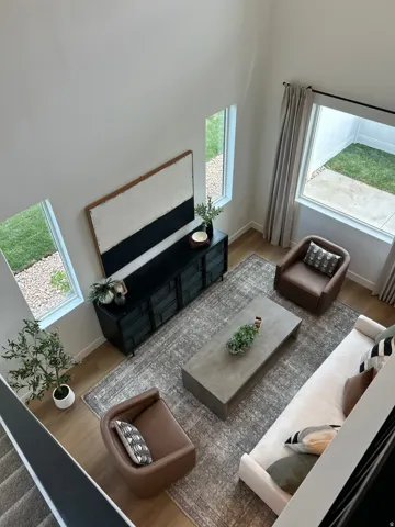 Two-story living area featuring high ceilings and wood-finish flooring