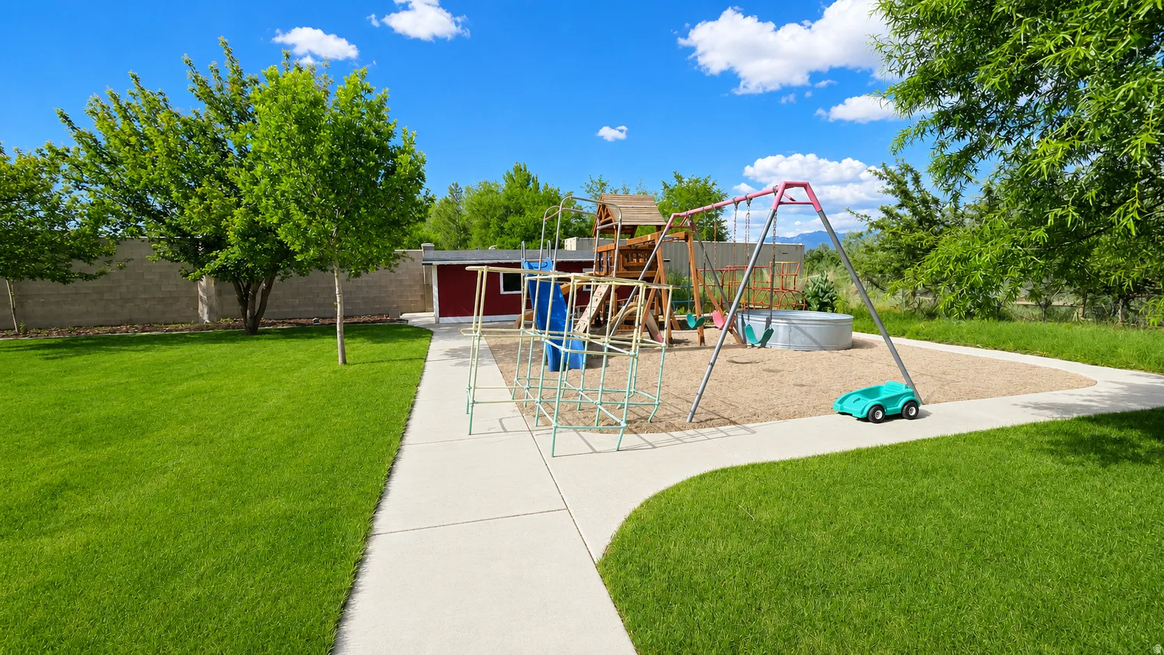 Expansive outdoor space featuring a playground area with a swing set and climbing structure