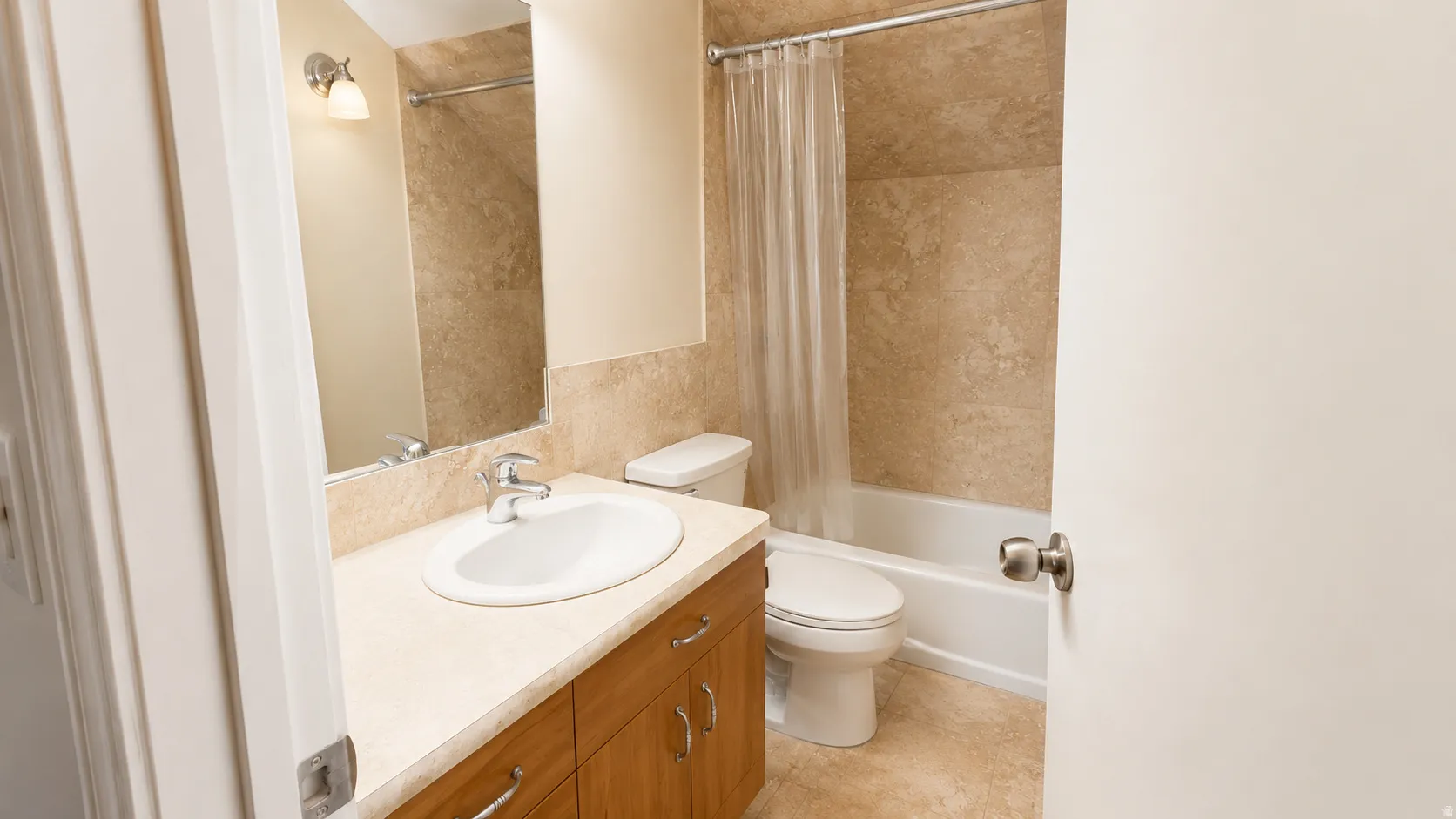 ADU #2 - Bathroom featuring a single vanity with wood-finish cabinetry and a light-toned countertop