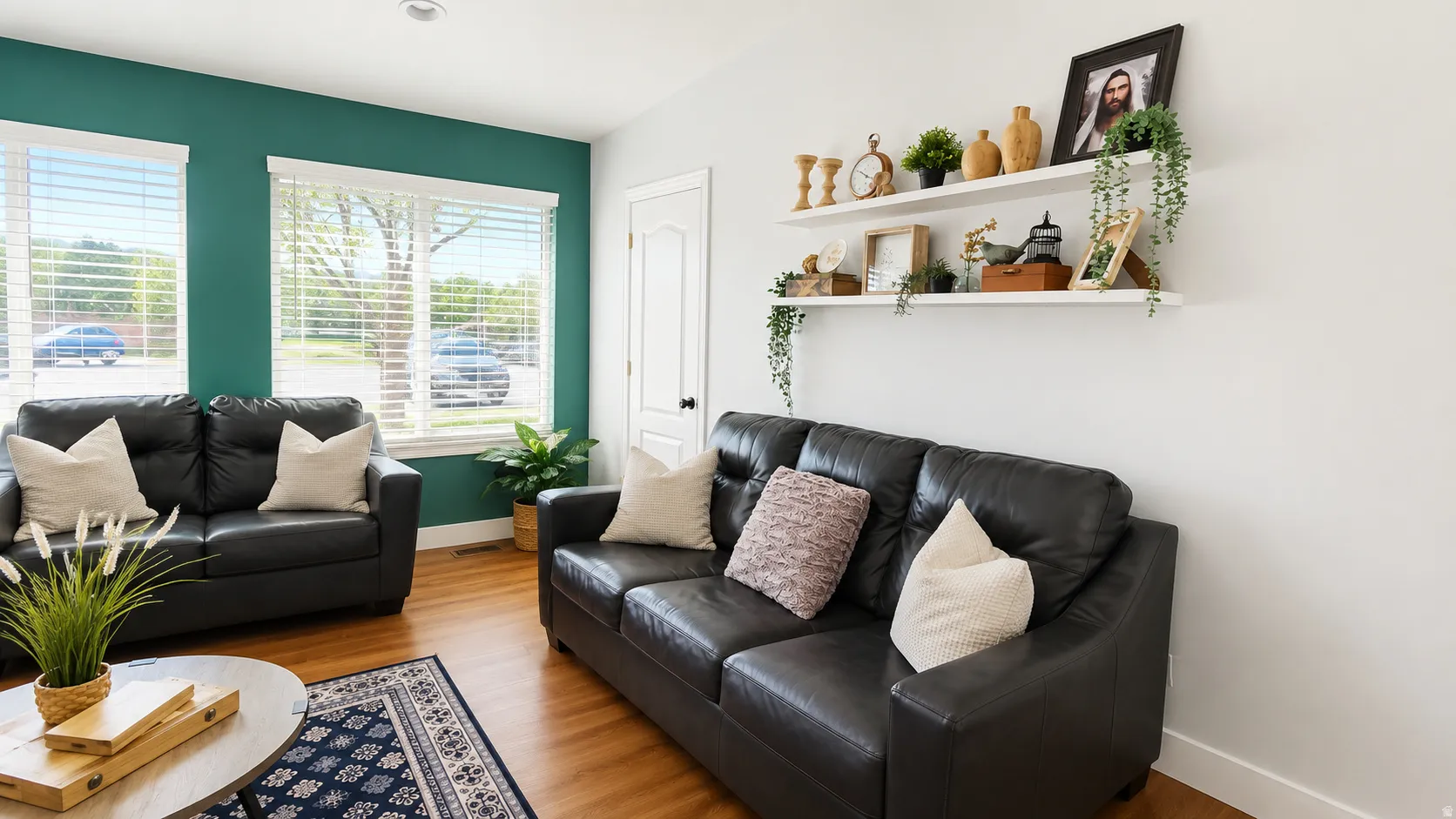 Living area featuring light wood-finish flooring, white baseboards, and a white interior door with dark hardware