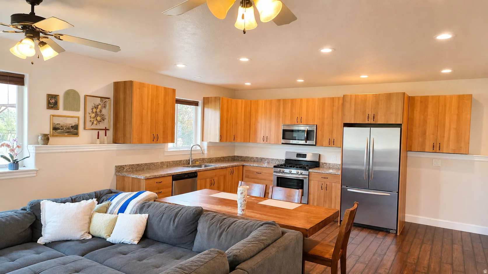 ADU #1 - Kitchen/Living room area featuring light wood cabinetry, stainless steel appliances, recessed lighting, and wood-finish flooring