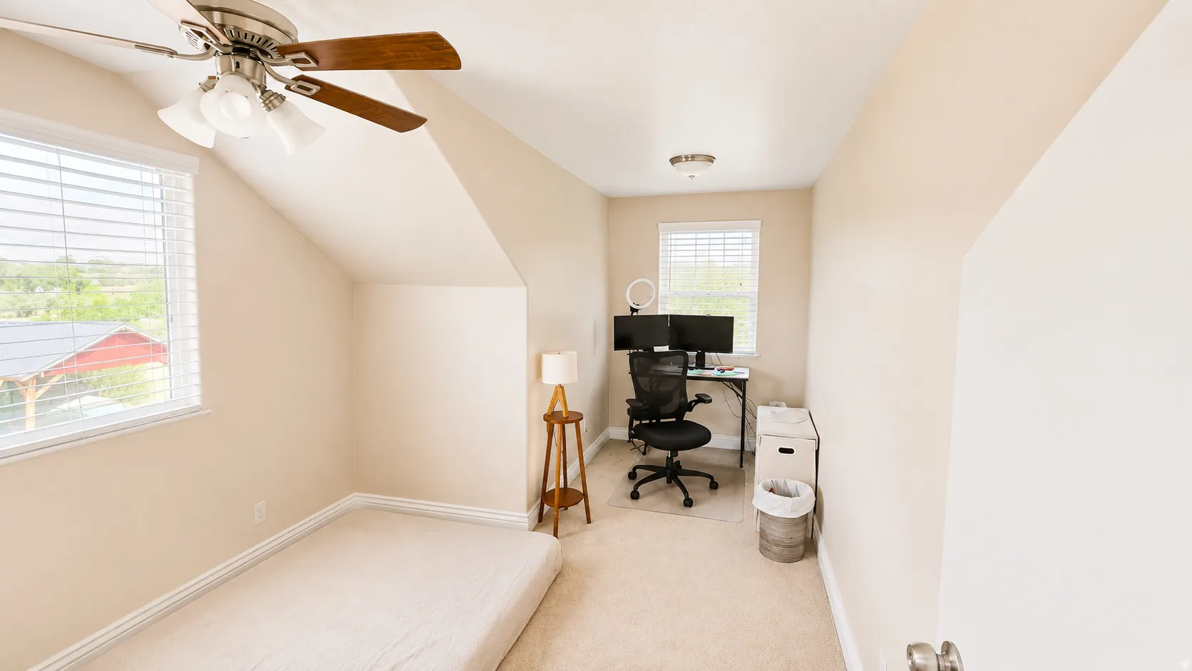 ADU #2 - Carpeted room featuring a ceiling fan with integrated lighting, a window with horizontal blinds, and sloped ceiling details