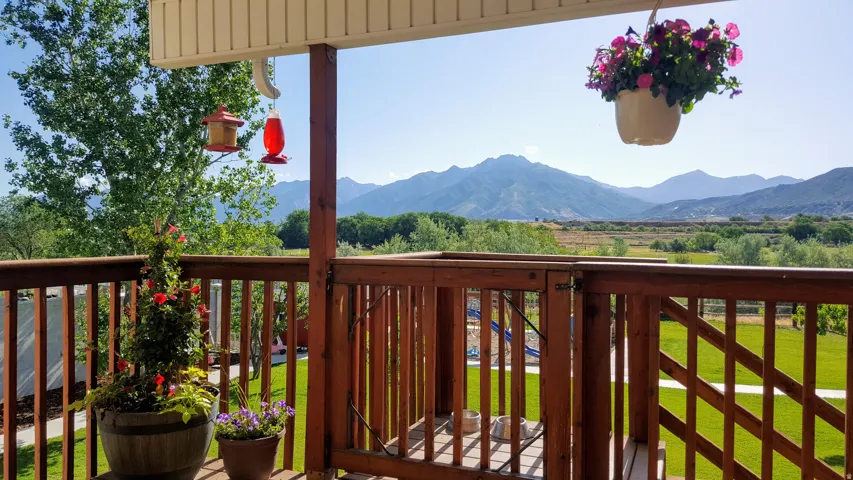 Expansive outdoor deck featuring a rich wood railing and balusters