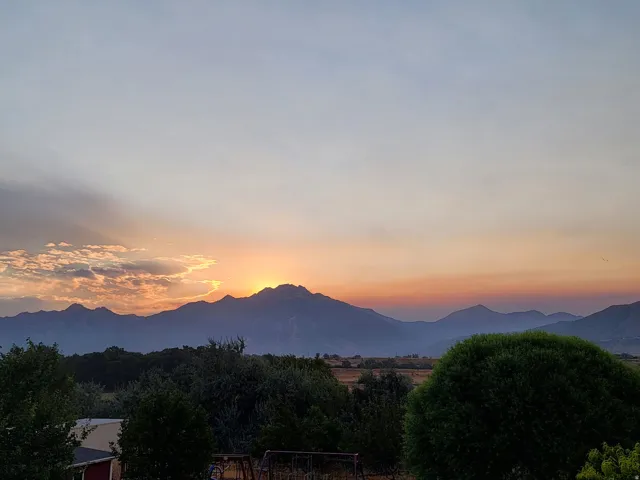 Expansive mountain range backdrop with a dramatic evening sky